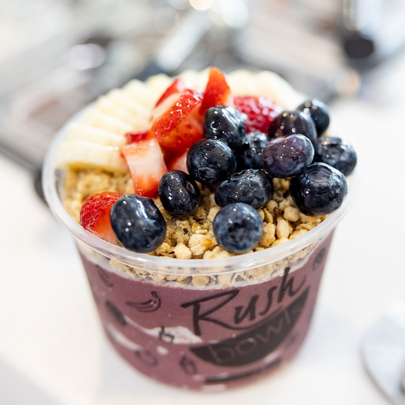A picture of a Rush Bowls blended fruit bowl, perfect for an on-the-go individual looking for a quick, nutritious, and delicious food option.