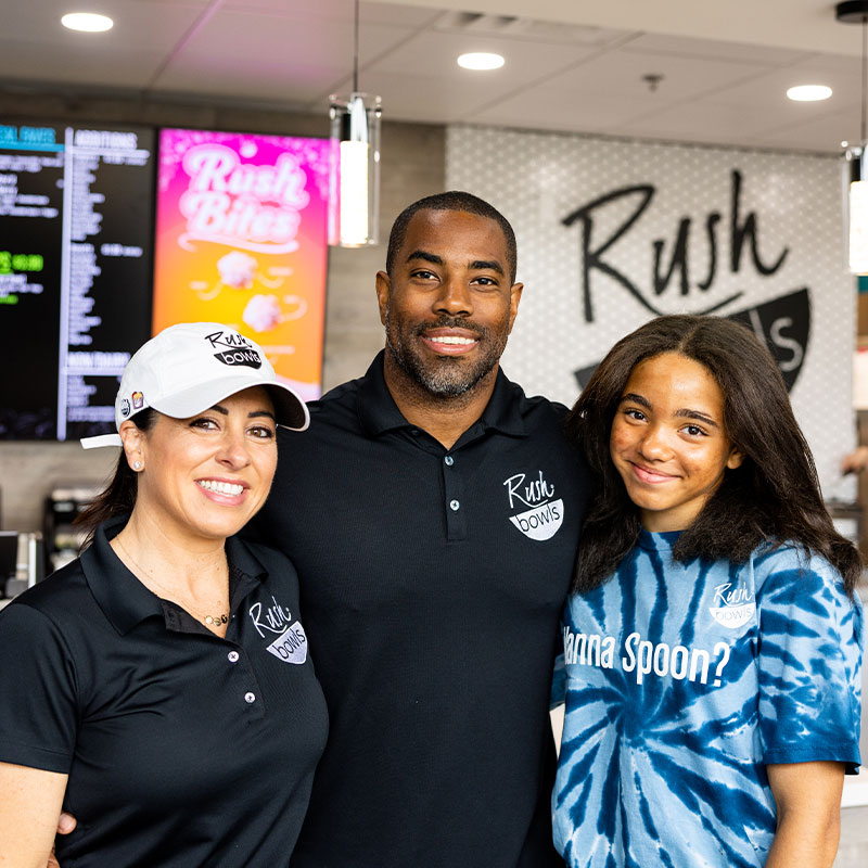 A Rush Bowls owner working and ready to help customers - learn how to start a health food franchise!