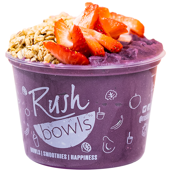 Granola crumble layered with strawberries on top of a purple smoothie bowl. 