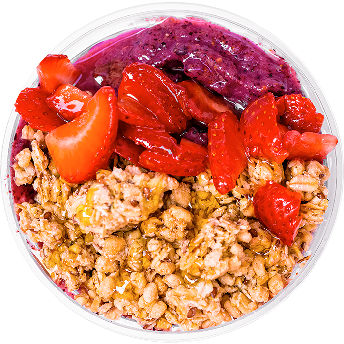 Organic hemp granola, strawberries, and honey toppers on a smoothie bowl. 