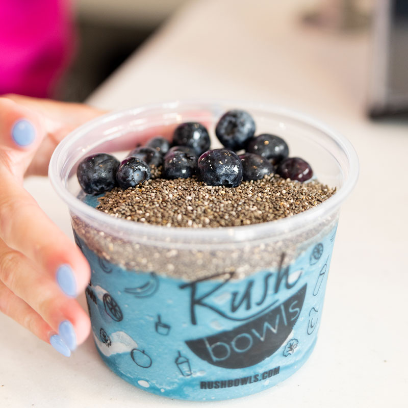 A delicious smoothie bowl in a trendy Rush Bowls location.