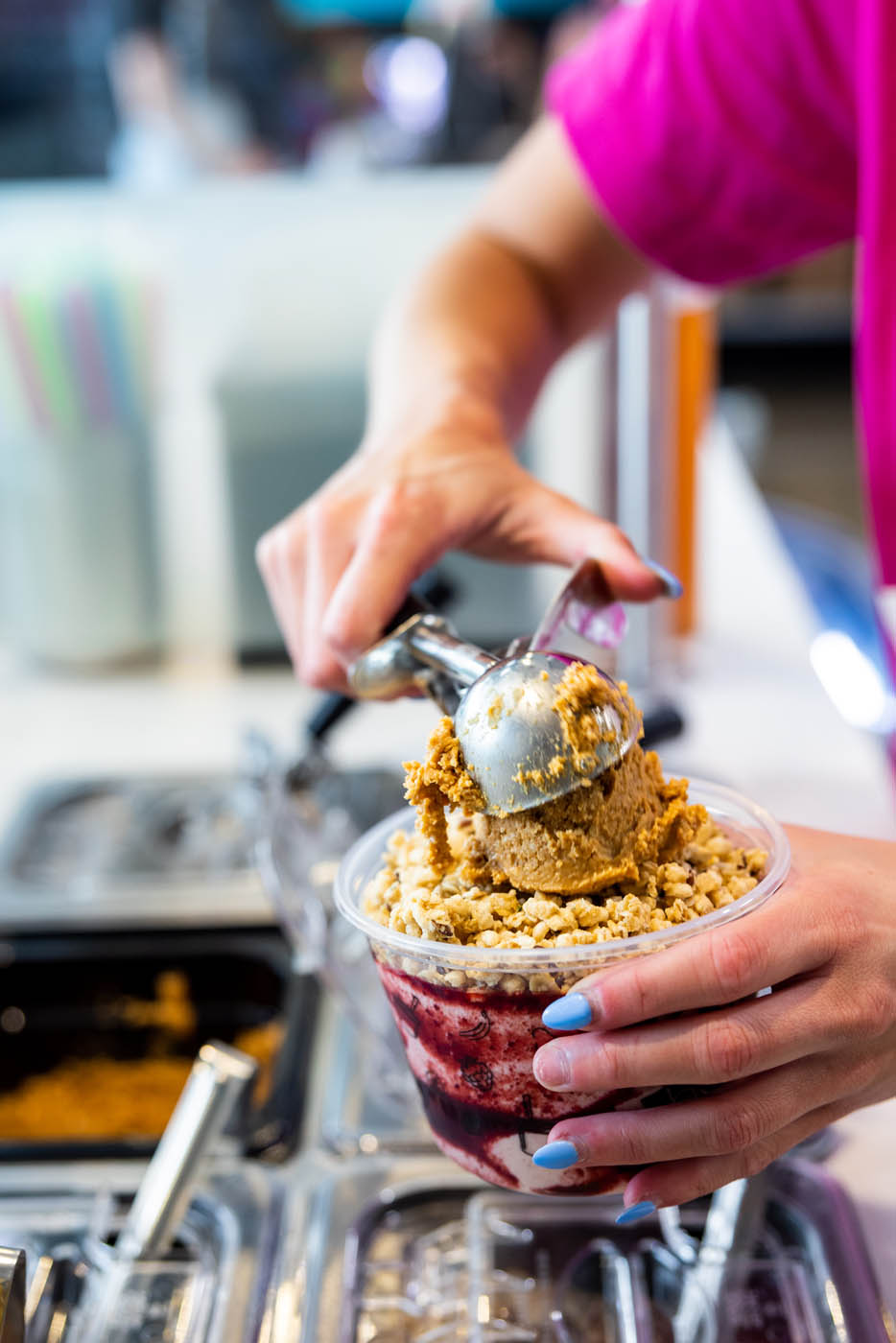 A Rush Bowls franchise owner preparing a smoothie bowl.