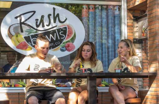A group of friends enjoy a healthy lunch at Rush Bowls.