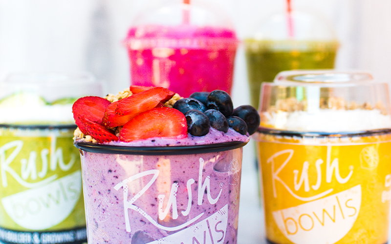 An assortment of colorful smoothie bowls with Rush Bowls - learn more about our franchise business model today!