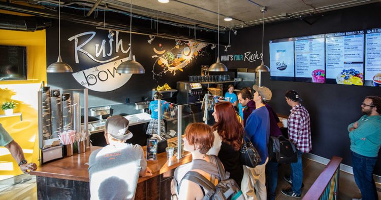 Customers in line at an acai bowl franchise restaurant