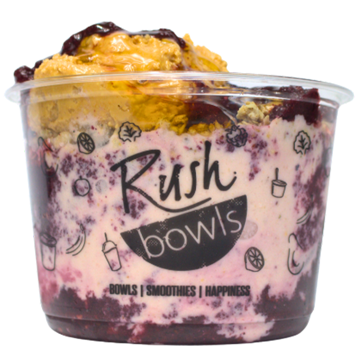 Our protein packed pb&j flavored smoothie bowl topped with honey. 