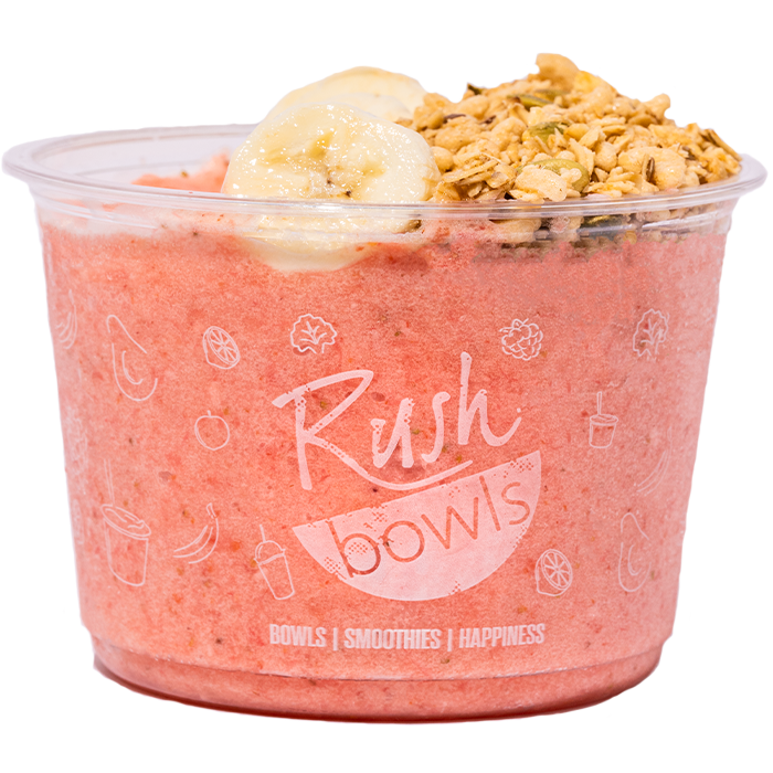 A pink Rush Bowls smoothie bowl with coconut, honey, and granola toppings. 