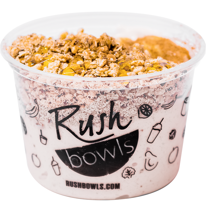 Cream colored banana flavored smoothie bowl topped with granola and cinnamon toppings.
